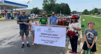 Friends of Schumacher at Tractor Fest with a parade sign