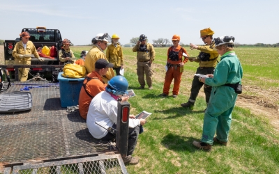 A group of volunteers being briefed at the beginning of a burn