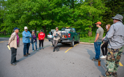 A group of volunteers getting a morning briefing from DCP staff on weeds at the park.