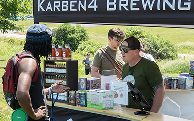 A person ordering something from the Karben4 booth