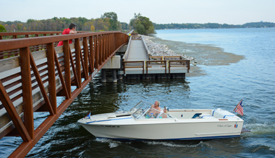 Boat going under the Lower Yahara River Trail bridge