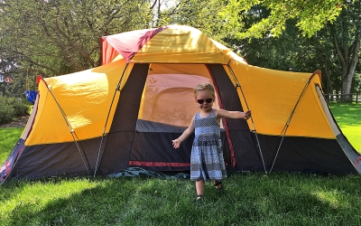 child at entrance of tent