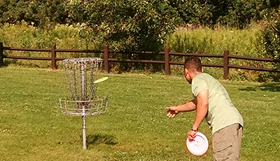 Throwing a disc into the basket