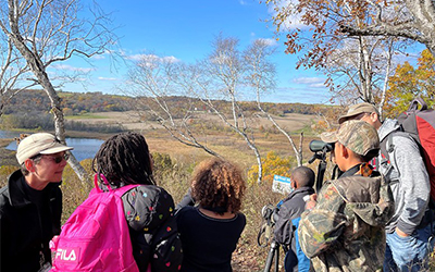 A group of people looking out over the scenic overlook
