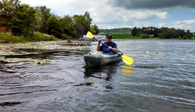 Person Kayaking on Fish Lake with an overcast sky