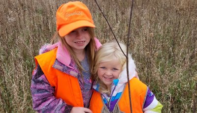 Two girls wearing orange vest