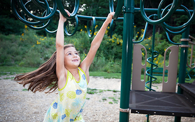 Girl on monkey bars