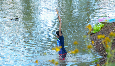 Child jumping into the water at Salmo Pond