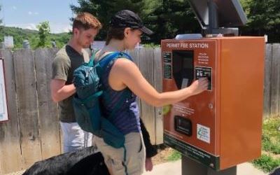 visitors purchase a permit at an electronic pay station